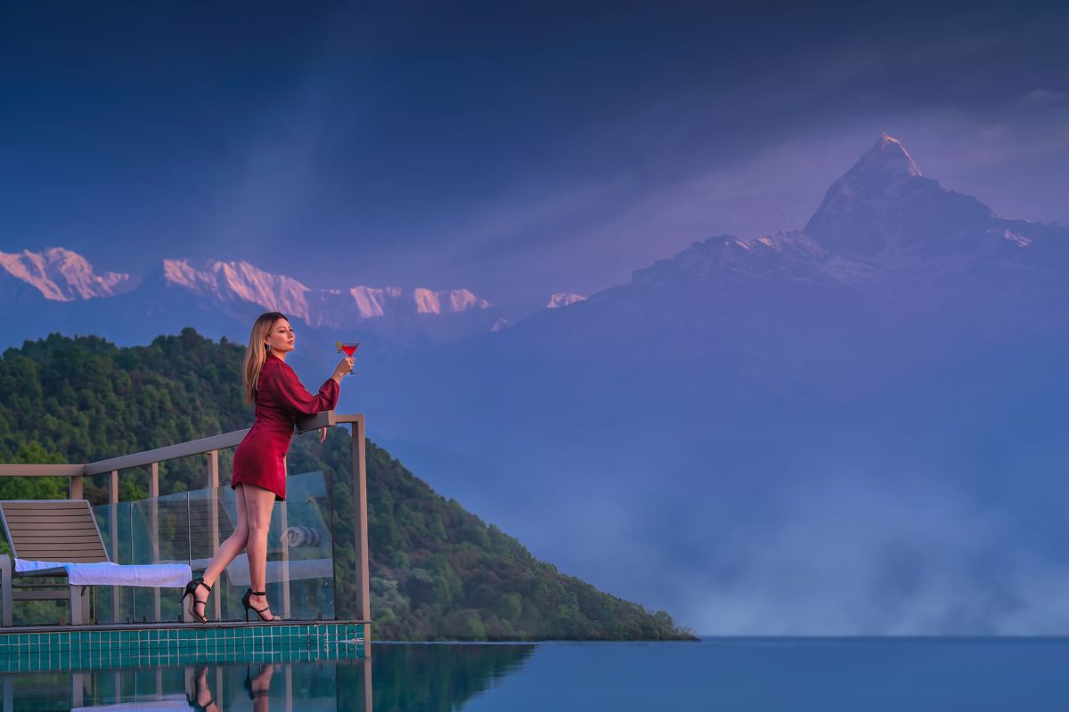 Woman enjoying view from poolside at Sarangkot. Things to do in Sarangkot